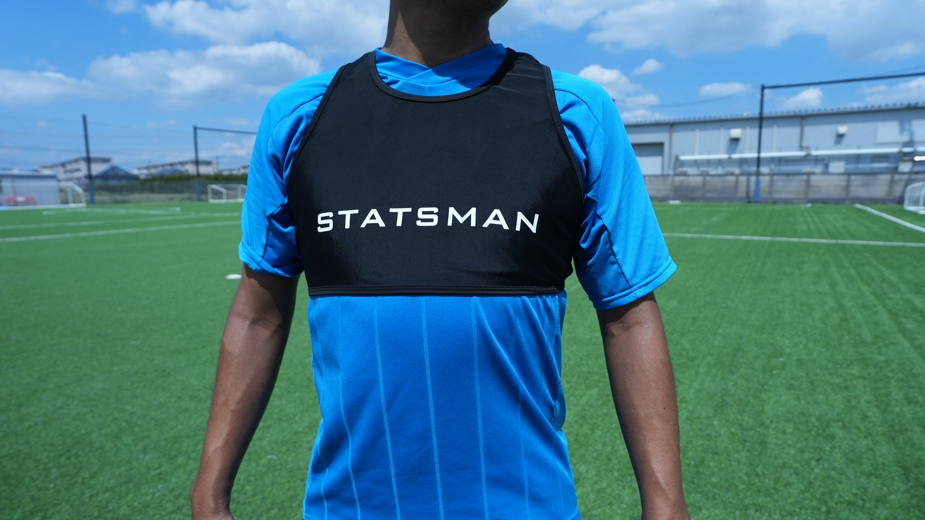 サッカーユニフォームの上から STATSMAN 専用ベストを着用した正面